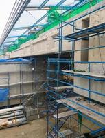 Side view of the large building of the monorail station in under construction with the scaffolding. photo