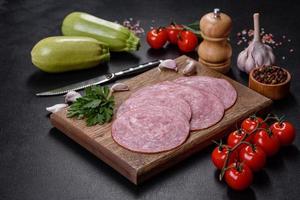 Slices of delicious fresh sausage on a wooden cutting board