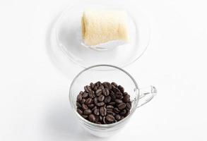 Dark coffee beans with soft roll cake. photo