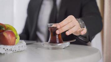 Businessman drinking tea. Putting the teacup on the table. Drink tea. video