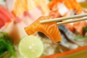 salmon sashimi with sashimi set background photo