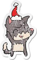 happy distressed sticker cartoon of a fox wearing santa hat vector