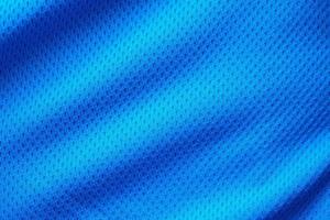 Blue fabric sport clothing football jersey with air mesh texture background photo