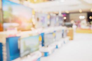 Television shelf in eletronic department store blurred background photo