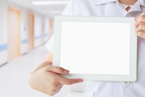 Doctor showing digital tablet with blank screen at the hospital photo