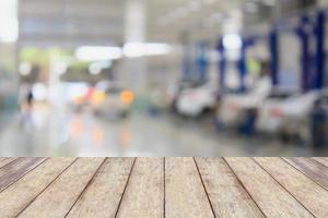 Wood table top with blur garage background photo