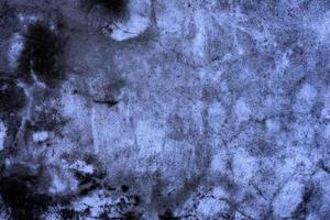 Texture of a concrete wall with cracks and scratches which can be used as a background photo