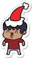 sticker cartoon of a laughing boy wearing santa hat vector