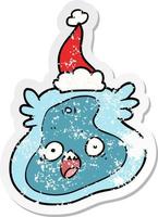 distressed sticker cartoon of a germ wearing santa hat vector