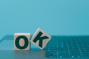 Lettering the word OK on a wooden block photo