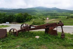 An old rusty one-bottomed iron plow for plowing the soil for vineyards. photo