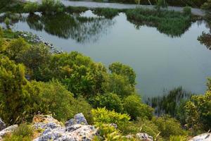 Mountain lake with gray rocks, top view. Landscape. photo