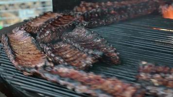 The process of frying pork ribs on the grill in a restaurant video