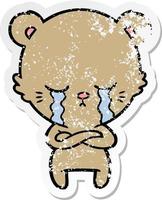 distressed sticker of a crying cartoon bear with folded arms vector