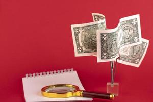 Money tree from dollar bills, on a red background. Copy space. photo