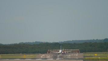 Passenger plane picking up speed for takeoff, front view. Haze on the airfield from hot weather video