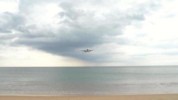 Airplane approaching over ocean before landing on the Phuket airport. Mai Khao beach video