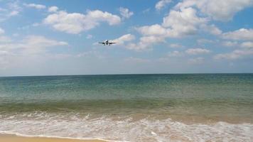Düsenflugzeug im Endanflug vor der Landung am internationalen Flughafen von Phuket, schöne Wellen am Strand, Zeitlupe. video