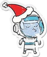 distressed sticker cartoon of a confident astronaut wearing santa hat vector