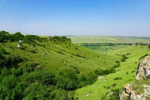 A picturesque view of the green steppe hills, pastures stretching into the distance. photo