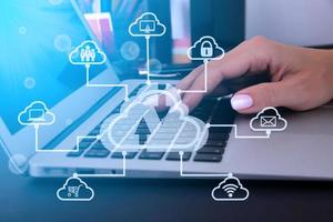 Business woman using laptop computer with virtual cloud technology with icon. Cloud technology big data management includes business strategy, customer service. photo