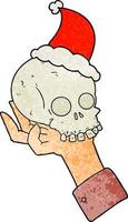 caricatura texturizada de una mano sosteniendo un cráneo con sombrero de santa vector