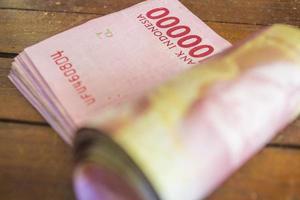 Selective focus of red one hundred thousand rupiah rolls photo