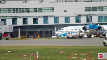 DUSSELDORF, GERMANY JULY 21, 2017 - Passenger plane Boeing 737 of ASTRA taxis to the terminal at Dusseldorf airport. Astra Airlines Greek airline video