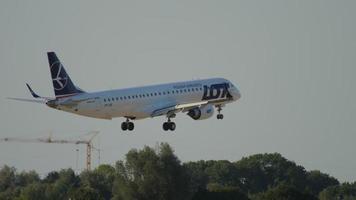 DUSSELDORF, GERMANY JULY 21, 2017 - Embraer E195LR, SP LNE of LOT landing at Dusseddorf airport. Tourism and travel concept, air flight video