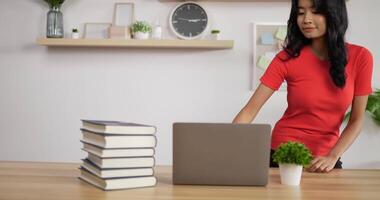 Portrait of Asian schoolgirl studying online via laptop at home. Distance learning and education concept. video