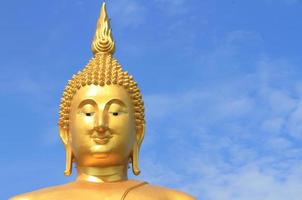 Big Buddha image on blue sky background photo