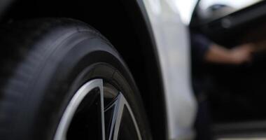 Close up of Asian automobile mechanic checking a car tyre on road. Service maintenance insurance with car engine. Car service concept. video