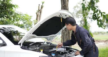 Asian automobile mechanic check engine oil level. Service maintenance insurance with car engine. Car service concept. video