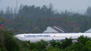 PHUKET, THAILAND NOVEMBER 28, 2019 - Commercial airplane of Airbus A330 Turkish Airlines on airfield at Phuket airport. Turkish Airlines flag carrier of Turkey. Tourism and travel concept video