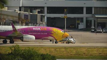 PHUKET, THAILAND NOVEMBER 28, 2016 - NOK Air boeing 737 HS DBS push back before departure, Phuket international airport video