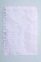 white paper with crumpled lines placed on a blue background photo