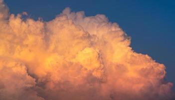 Blue sky and white fluffy clouds on sunset sky. White cumulus clouds. Dramatic sky and clouds abstract background. Warm weather background. Art picture of clouds at dusk. Cloudy sky. photo