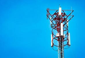 Telecommunication tower with clear blue sky background photo