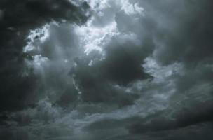 Dark dramatic sky and clouds. Background for death and sad concept. Gray sky and fluffy white clouds. Sad and moody sky. Nature background. Dead abstract background. Cloudscape. Hope in darkness day photo