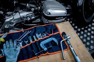 CHONBURI, THAILAND- SEPTEMBER 10, 2017 Tool set on the table with black and white scene single cylinder head cover in BMW motorcycle shop photo