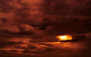 Dramatic red cloudy sky abstract background. Red and black clouds on sunset sky. Warm weather background. Art picture of sky at dusk. Sunset abstract background. Dusk and dawn concept. Cloudscape. photo