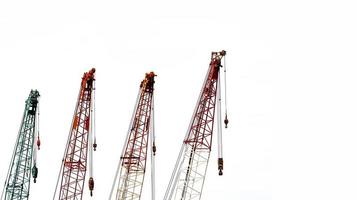 Set of big construction crane for heavy lifting isolated on white background. Construction industry. Crane for container lift or at construction site. Crane rental business concept. Crane dealership. photo