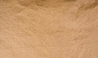 Old wrinkled brown paper texture background. Rough brown kraft paper texture. Recycle cardboard sheet. Rustic background pattern design. Closeup crumpled paper bag. Grunge and creased parchment. photo