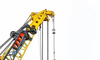 Big yellow construction crane for heavy lifting isolated on white background. Construction industry. crane for container lift or at construction site. Crane rental business concept. Crane dealership. photo