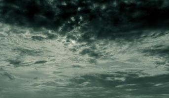 Dark dramatic sky and clouds. Background for death and sad concept. Gray sky and fluffy white clouds. Thunder and storm sky. Sad and moody sky. Nature background. Dead abstract background. Cloudscape. photo