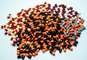Pile of colorful antibiotic capsule pills. Pharmaceutical industry. Drug production. Pharmacy drugstore background. Global healthcare. Drug interaction. Antibiotic drug resistance. Health budget. photo