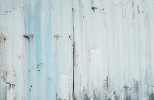 Galvanized sheet painted with white color. Empty white wall texture background. Peeling paint on white wall. Distorted striped gray galvanized sheet. Empty white and blue background for minimal life. photo