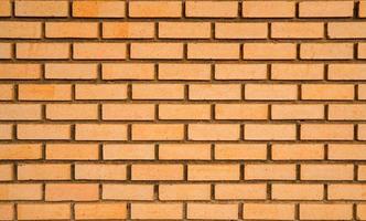 Orange brick wall texture background with space for text photo