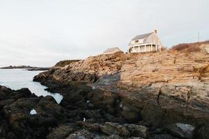 House by the ocean at golden hour photo