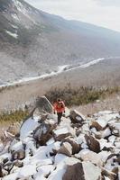 Person hiking on a snowy mountain photo